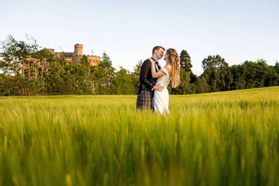 Couple in field opposite castl