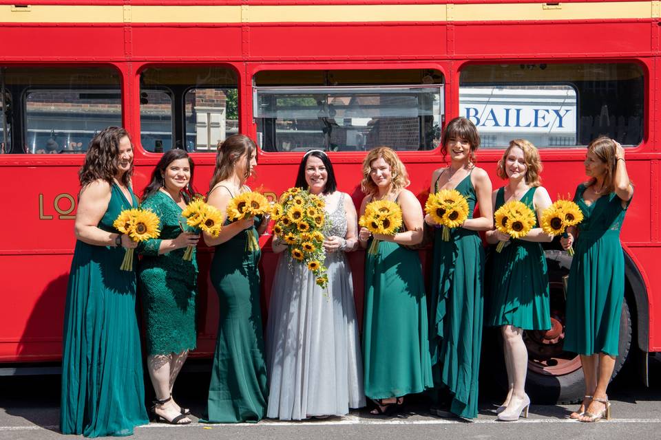 Bridal party and red bus