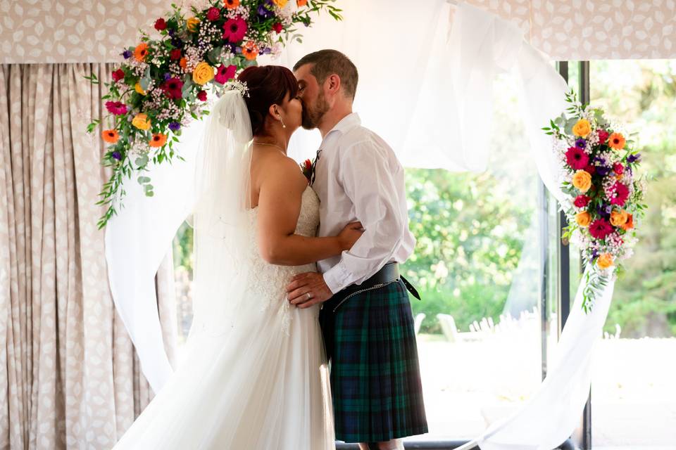 Bride and groom kiss