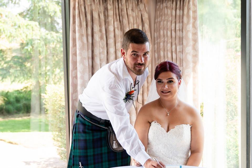 Bride and groom signing the re