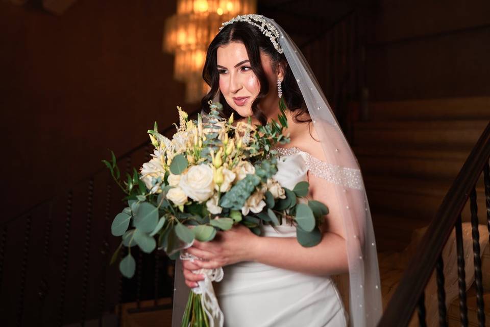 Bride with bouquet on staircas