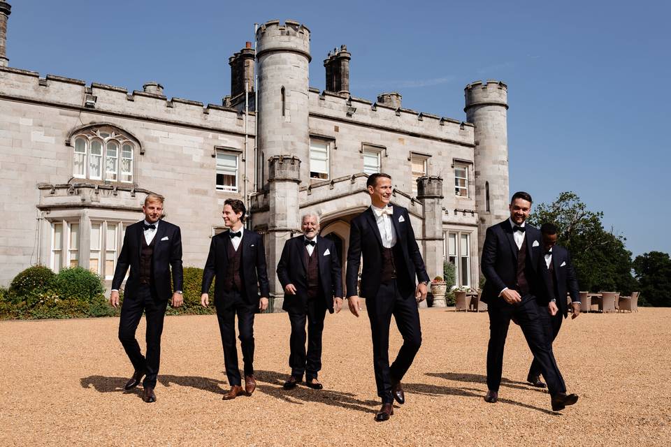 Groomsmen in front of castle