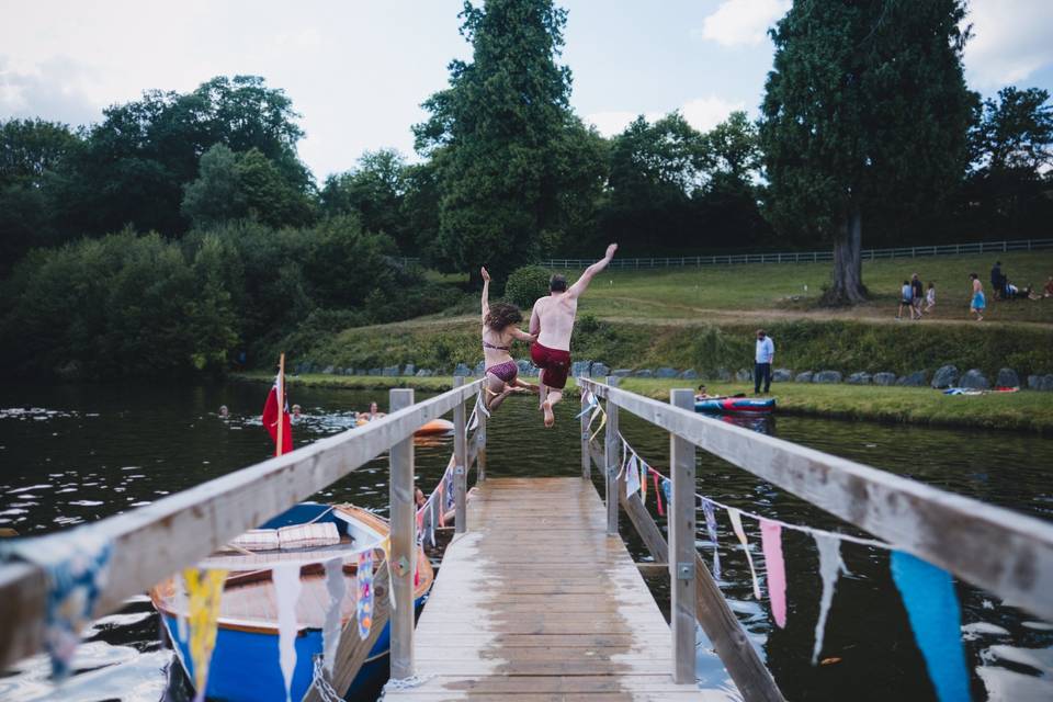 Couple jumping into lake