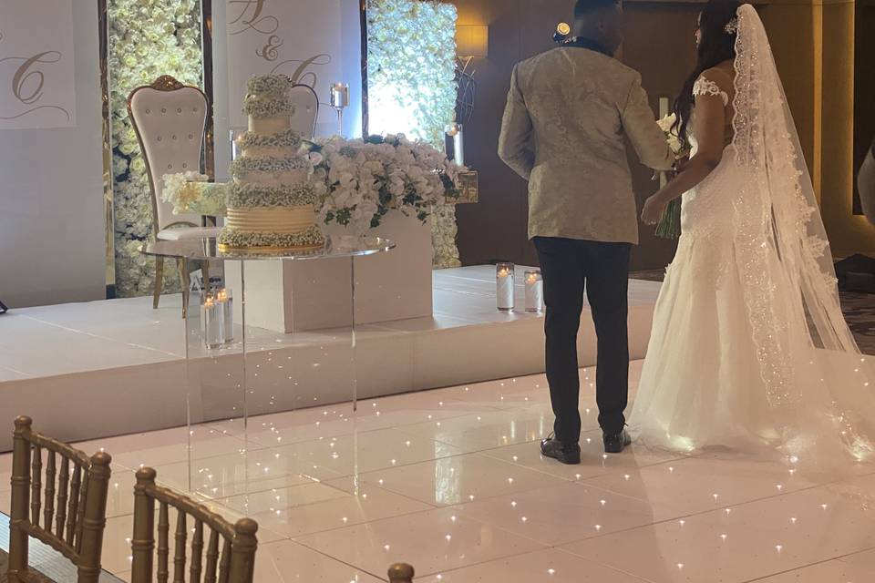 Newlyweds admiring the cake