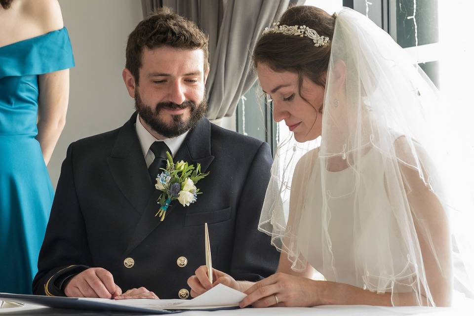 Bride signs the register