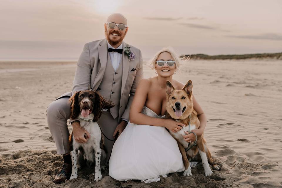 Couple with dogs on the beach