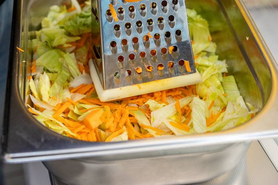 chef grating cabbage for coleslaw