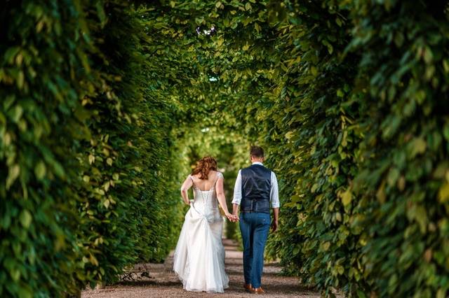 Couple beneath hornbeam arches