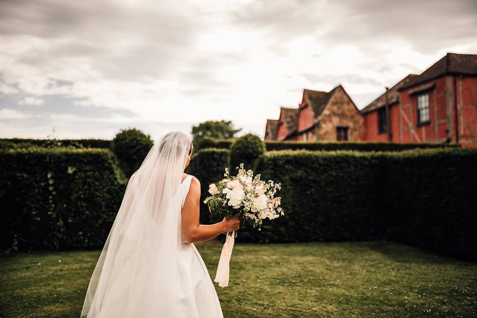 Bride amongst yew hedges