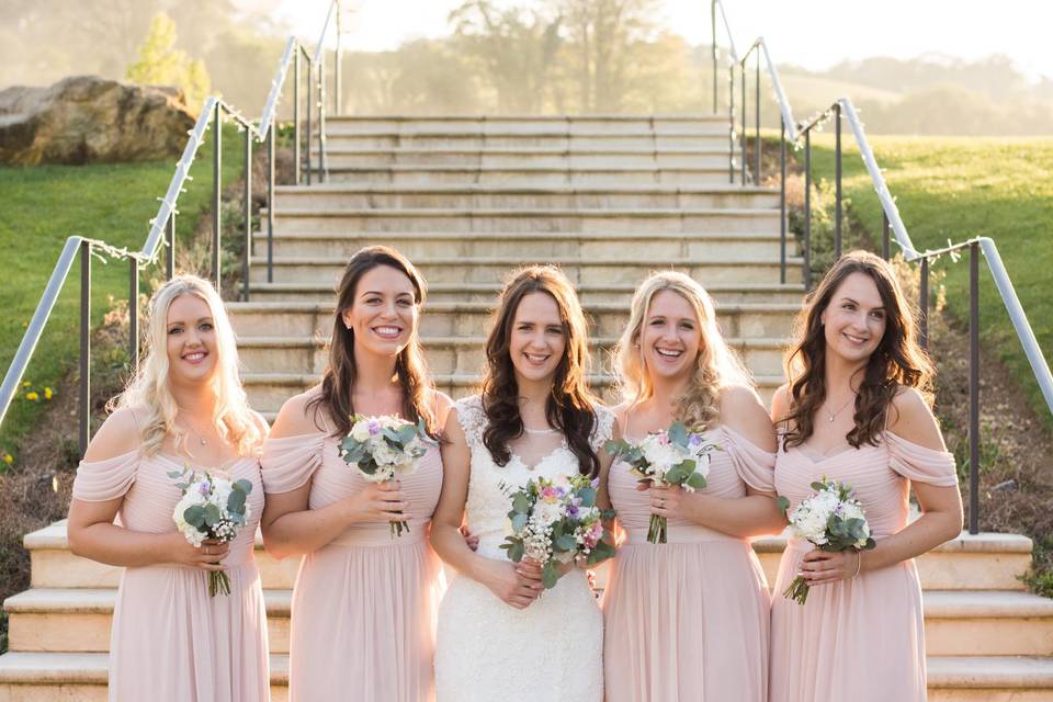 Wedding party outside holding bouquets