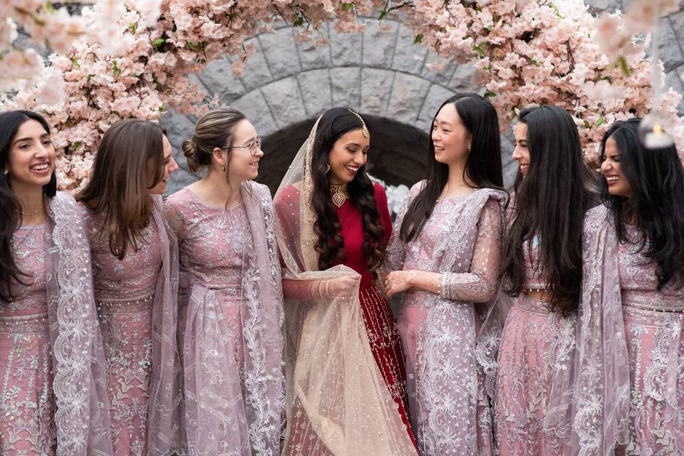 Wedding party and the guest-of-honour under a floral arch