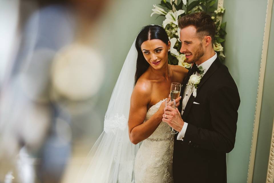 Newlyweds holding champagne glass