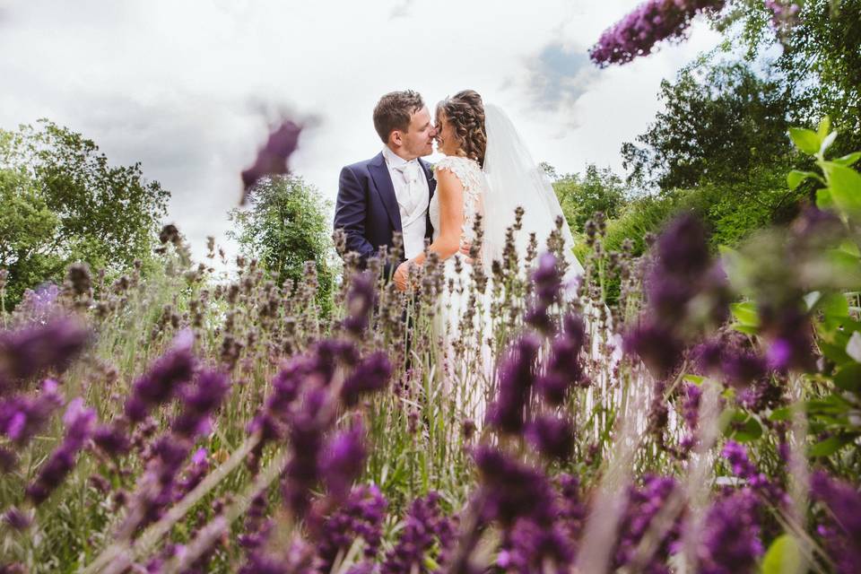 Newlyweds in a field of purple flowers