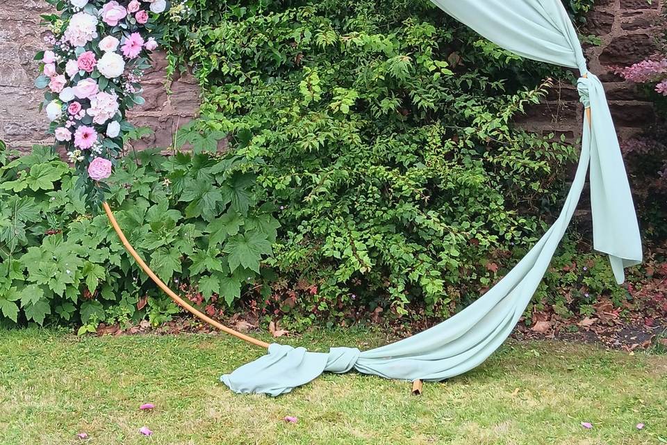 Pinks and sage green arch