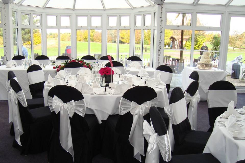 The Essex Golf & Country Club Black Linen Chair Covers with White Satin Sashes