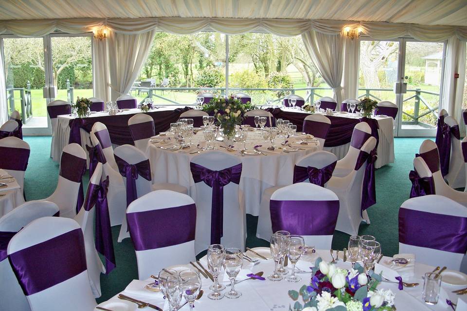 The Fennes Estate White Stretch Lycra Chair Covers with Dark Purple Satin Sashes