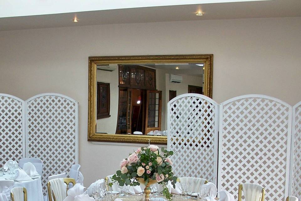 Wooden chairs and ivory chiffon vertical drapes
