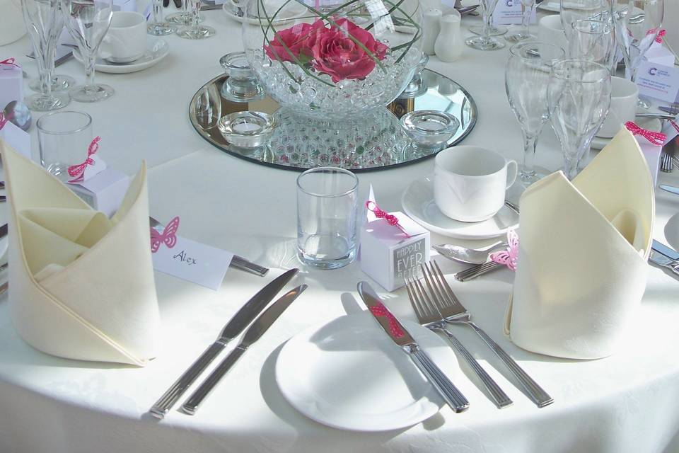 The Lawn Goldfish Bowl Centrepiece with Fuchsia Rose Heads, 40 cm. Round Mirror Plate & Glass Tea Light Holders