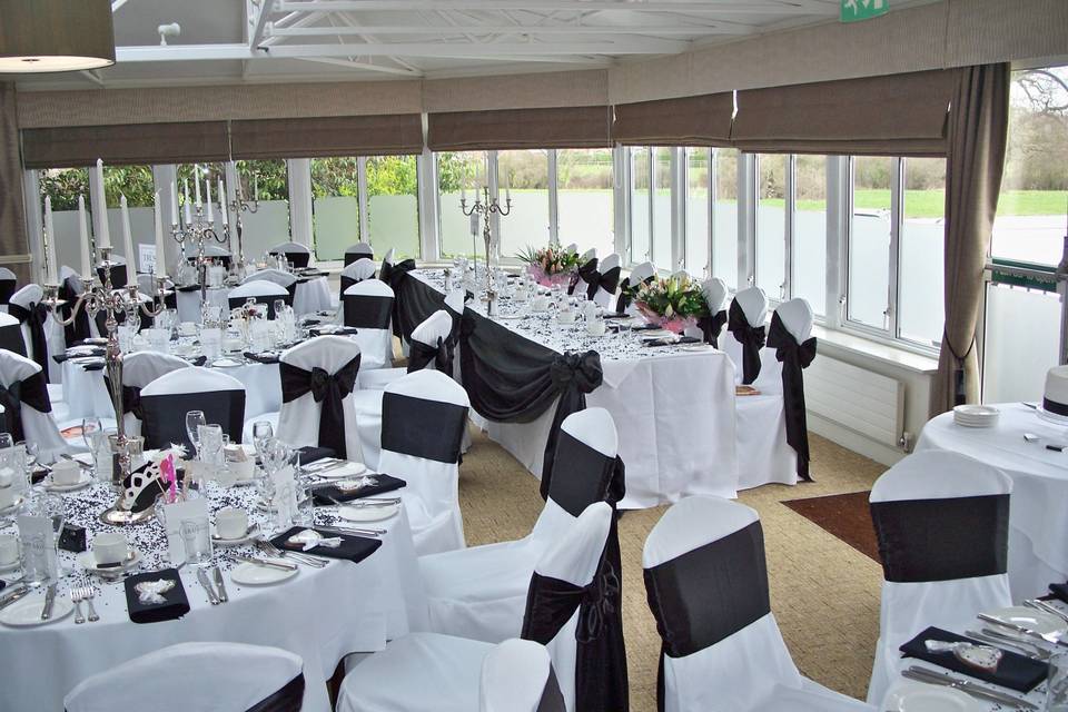 Pontlands Park (Conservatory) White Linen Chair Covers with Black Satin Sashes with 75 cm. Silver Candelabra for 5 Candles & Black Napkins