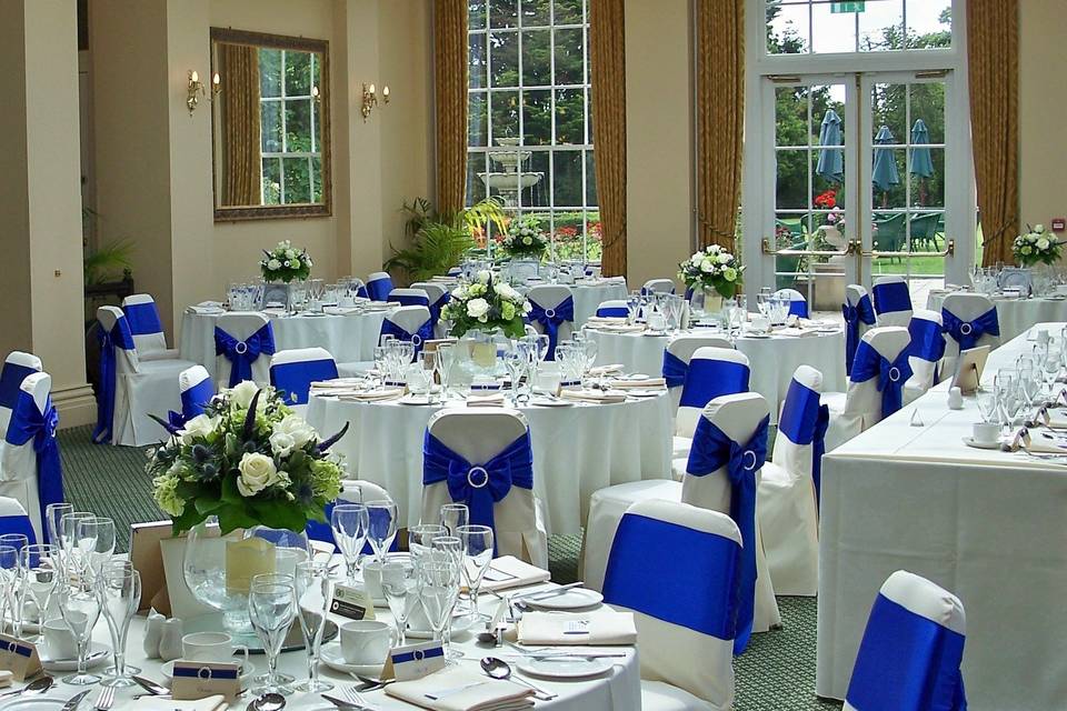 The Lawn Ivory Linen Chair Covers with Colbalt Blue Satin Sashes Finished With Round Diamante Buckles