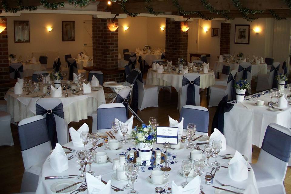 Little Channels White Stretch Lycra Chair Covers with Navy Blue Organza Sashes Finished With Round Diamante Buckles