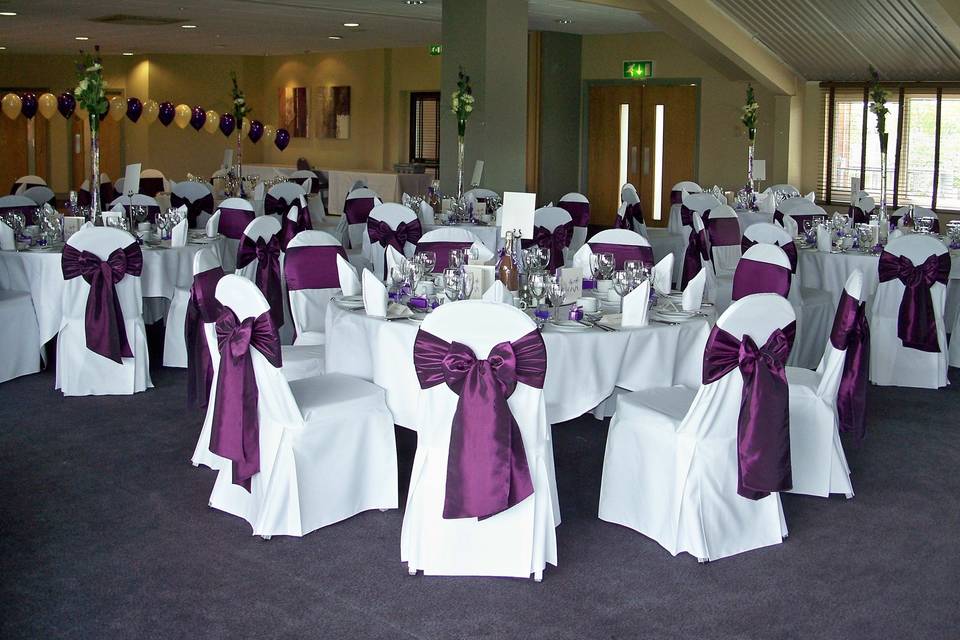 The Essex Golf & Country Club White Linen Chair Covers with Dark Purple Tafetta Sashes