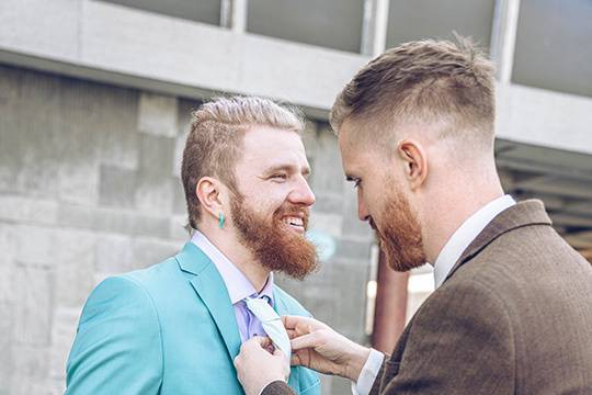 Best man adjusting groom tie