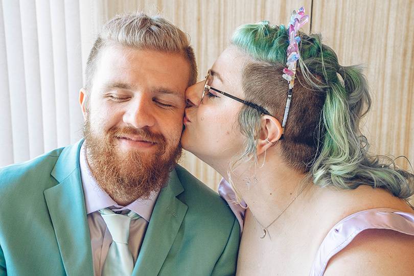 Bride kissing Groom cheek