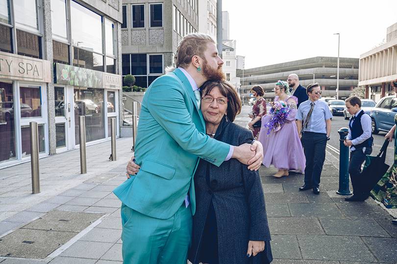 Groom hugs Mum