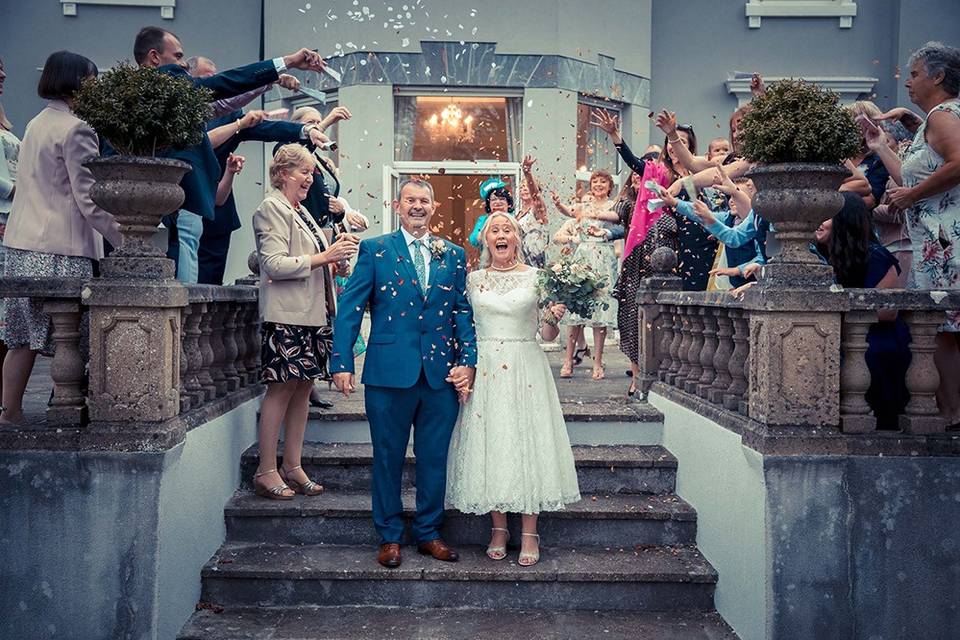 Bride and groom under confetti