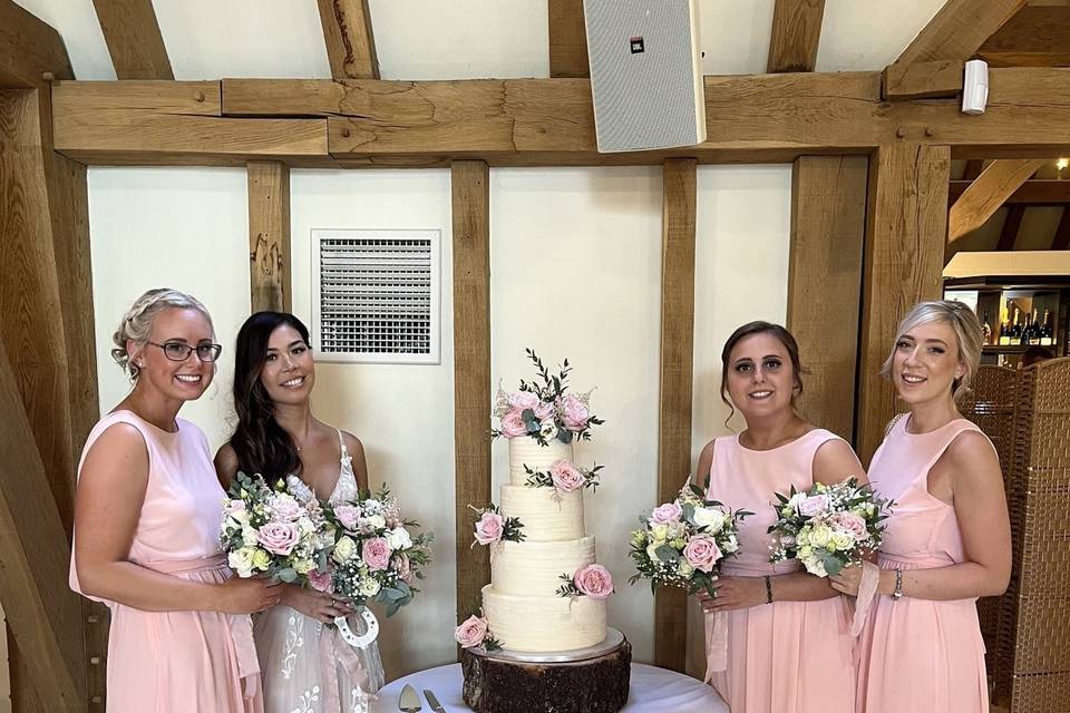 Bridesmaids with wedding cake