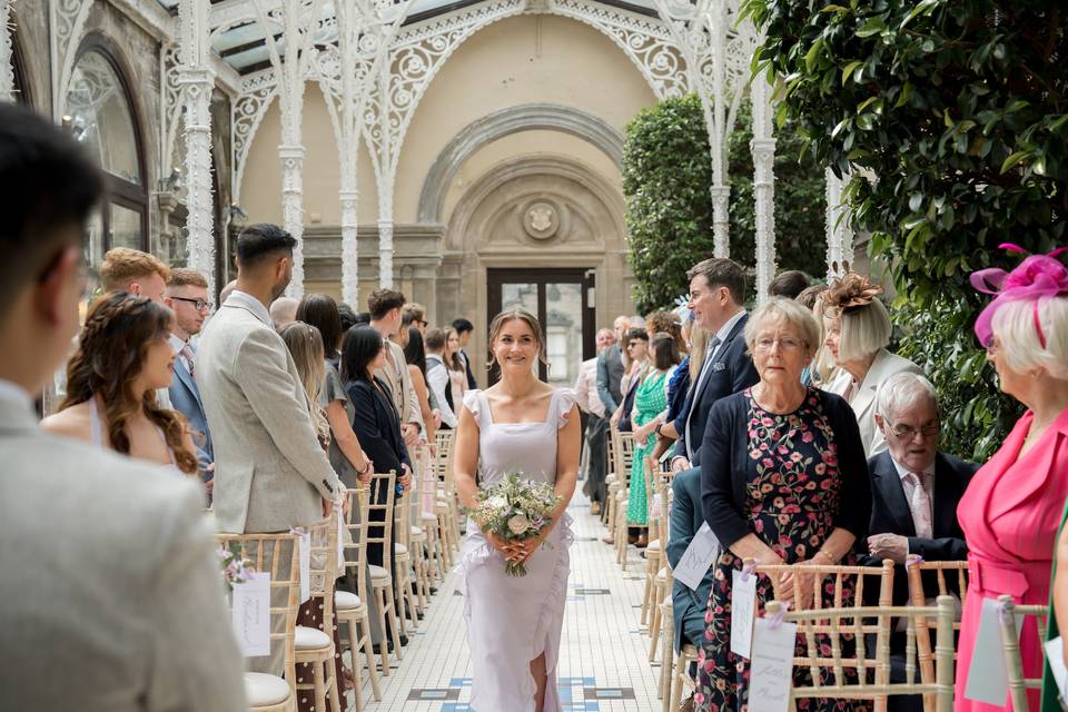 Bridesmaid walking down aisle