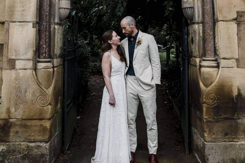 Bride & groom under stone arch