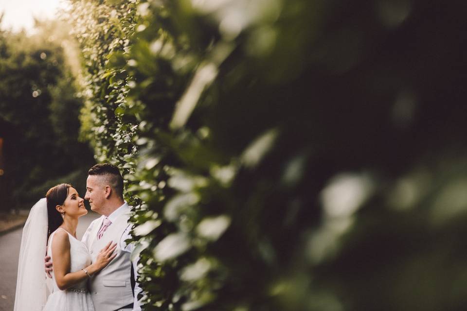 Couple standing by greenery