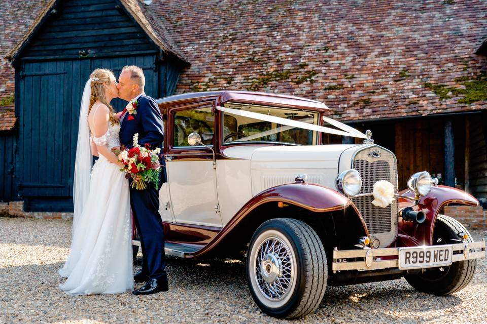 A kiss by the car