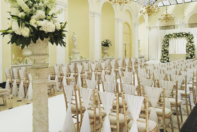 Florals, chair sashes, and arch