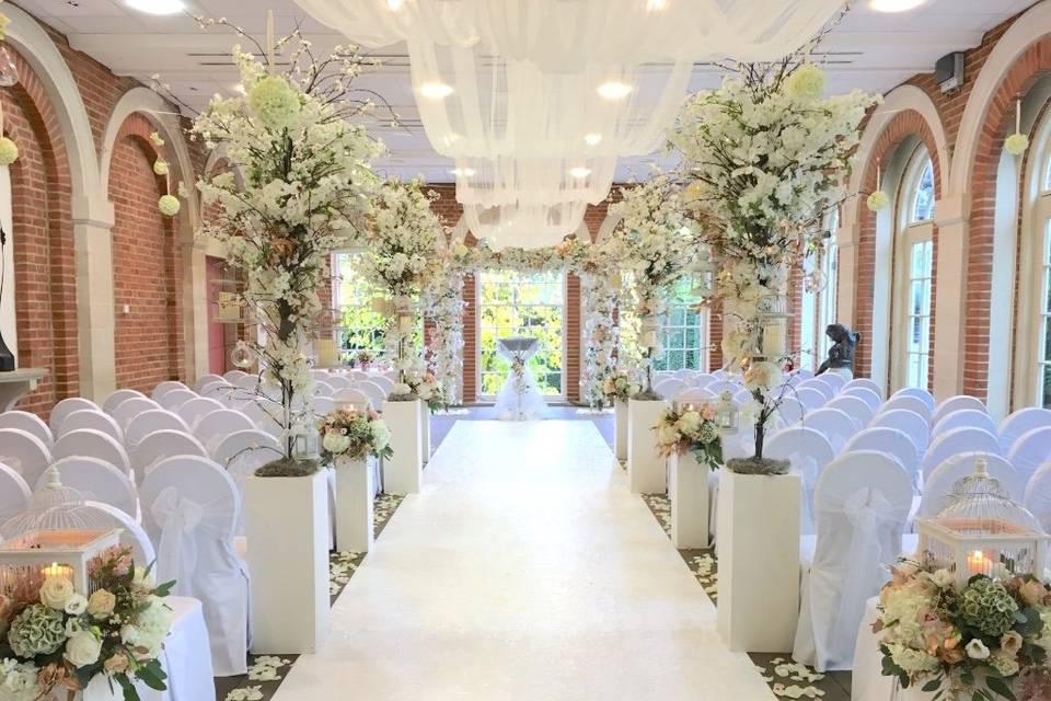 The orangery laid for a wedding ceremony