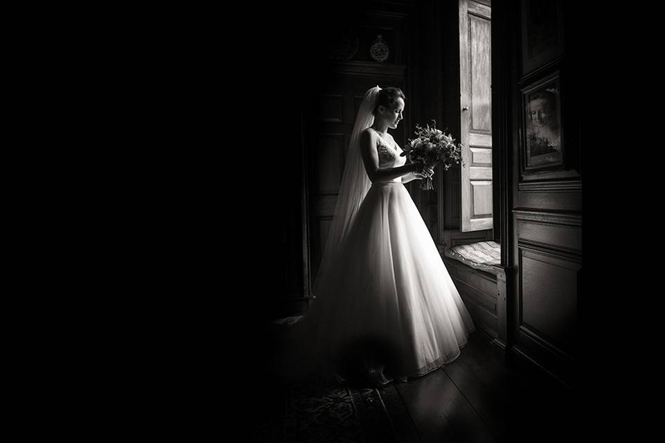 Bride standing by a window - Robin Goodlad Photography