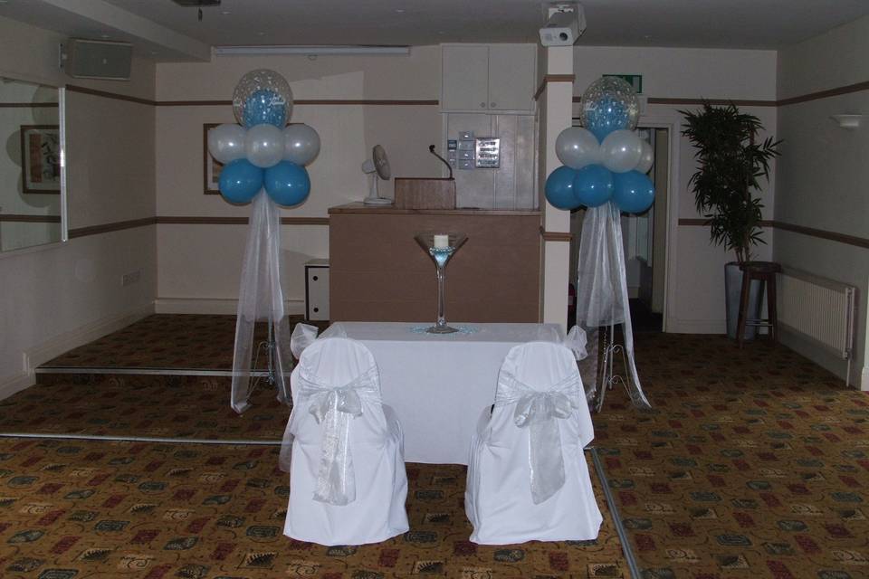 Registrars table with chair covers and cloud balloons