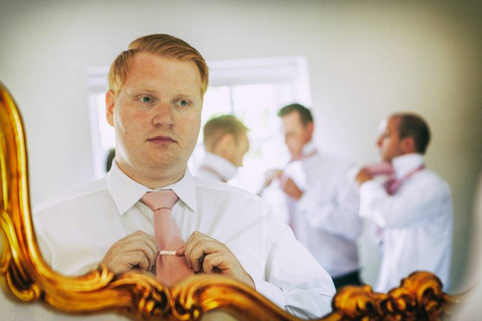 Groom straighten tie.