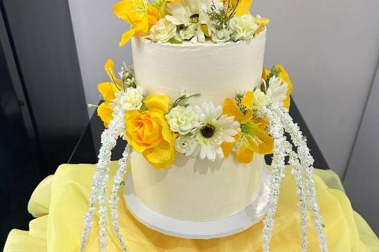 Two-tier sunflowers and roses wedding cake
