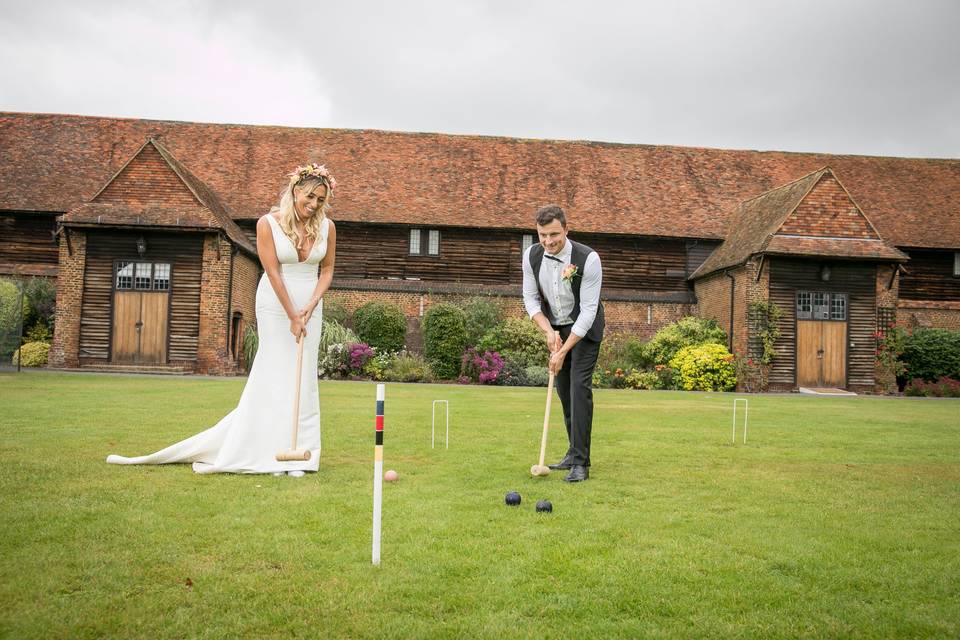 Newlyweds enjoying a game of croquet